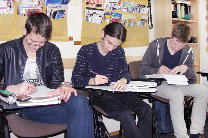 Filling out course evaluation forms at Terra Nova. From left to right: Cristian Corjan, Iurie Buzenco, and Vladislav Ciuș. TOEFL Preparation / Section 1 (M.W.F. Afternoon Group). April 2016.