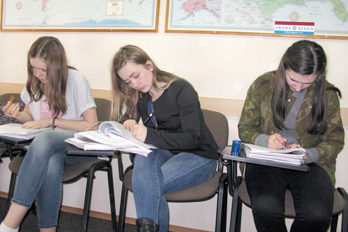 Filling out course evaluation forms at Terra Nova. From left to right: Alexandra Lazari, Iana Pînzari, and Gabriela Tecuci. TOEFL Preparation / Section 1 (M.W.F. Afternoon Group). April 2016.